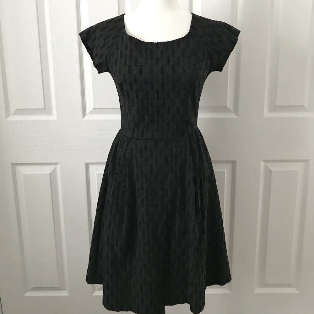 Black textured fit and flare dress with cap sleeve